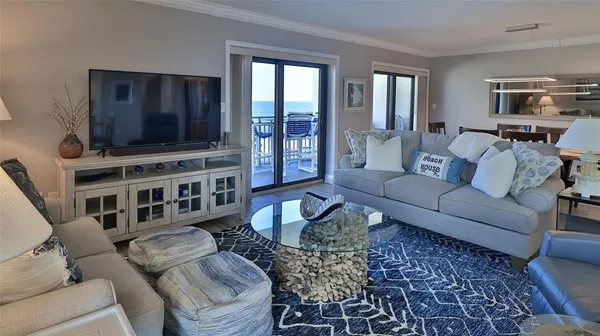 a living room with furniture fireplace and large window