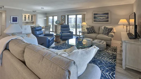 a view of a dining room with furniture wooden floor and fan