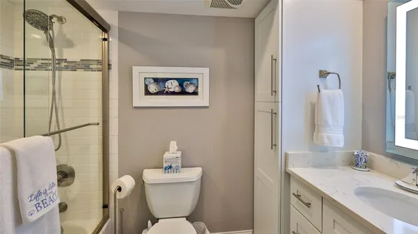 a kitchen with granite countertop a sink a stove top oven a counter space and cabinets
