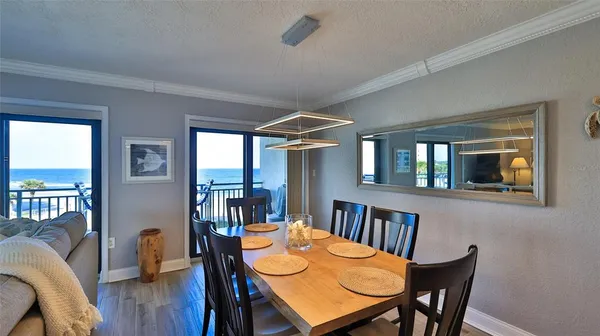a kitchen with stainless steel appliances granite countertop a dining table and chairs