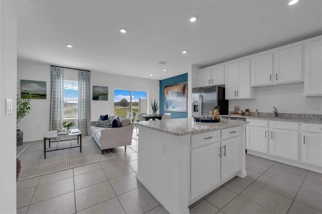 a kitchen with cabinets and chairs