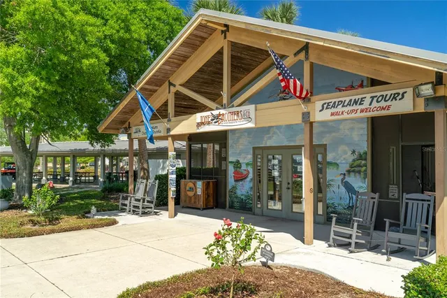 a room with pool table and windows