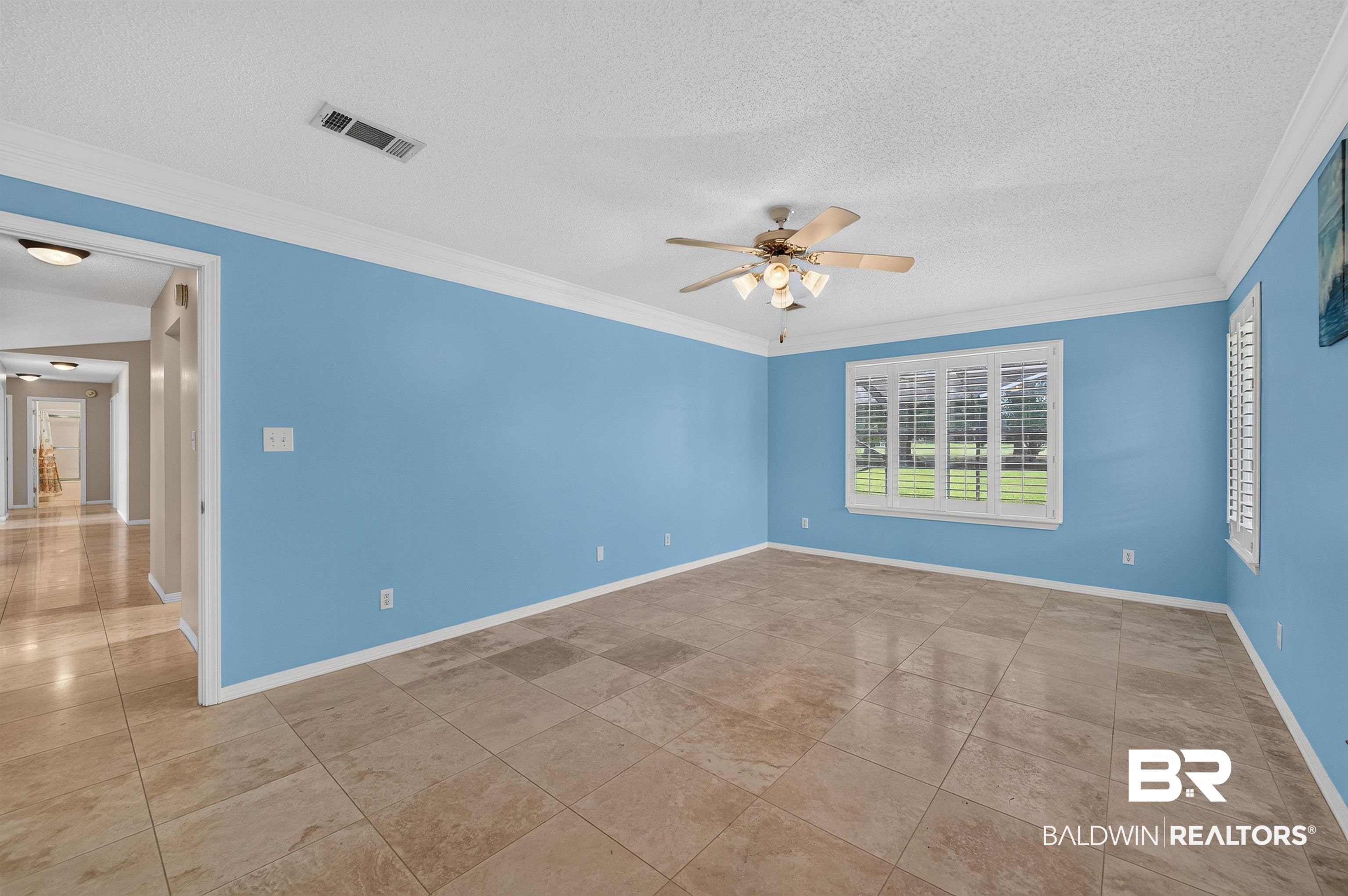 22685 County Road 12 Foley, AL 36535 - Photo 51 of 89 Spacious room featuring tile flooring, crown molding, and a ceiling fan