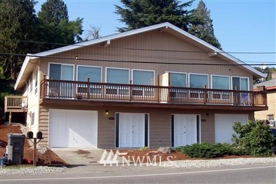 205 Hardie Avenue Southwest Renton, WA 98057 - Photo 1 of 1 a house that has a lot of windows and palm trees