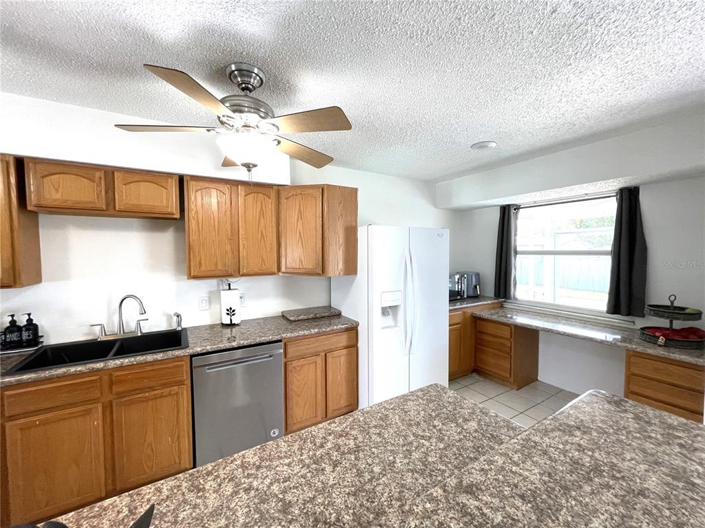 234 Shadow Street Northwest Port Charlotte, FL 33952 - Photo 17 of 48 a kitchen with a sink stove and cabinets