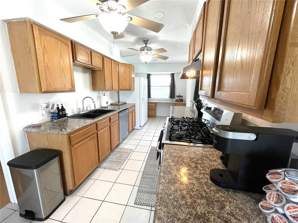 234 Shadow Street Northwest Port Charlotte, FL 33952 - Photo 20 of 48 a kitchen with sink refrigerator and cabinets