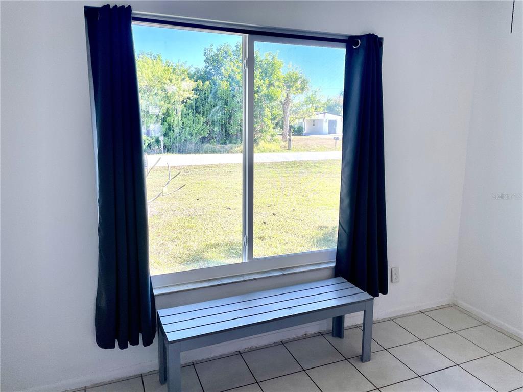 234 Shadow Street Northwest Port Charlotte, FL 33952 - Photo 23 of 48 a view of a floor to ceiling window and a room
