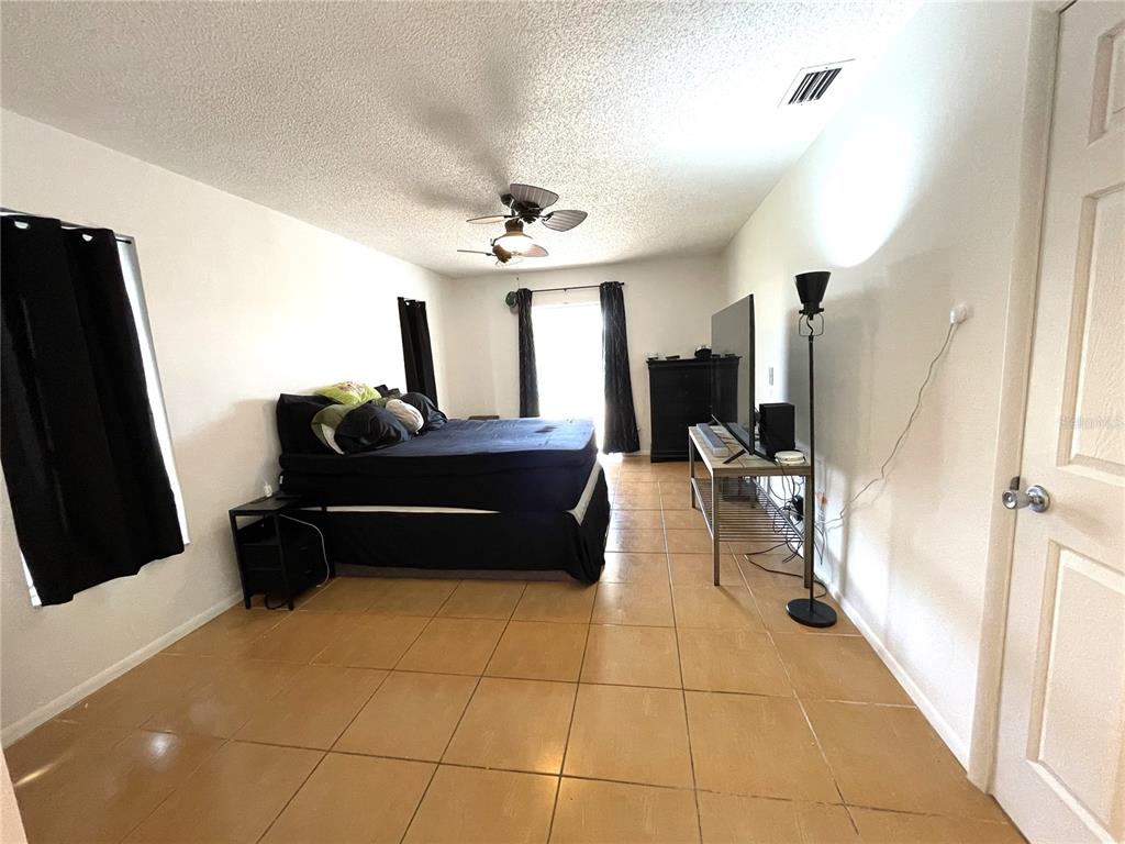 234 Shadow Street Northwest Port Charlotte, FL 33952 - Photo 25 of 48 a living room with furniture and a flat screen tv