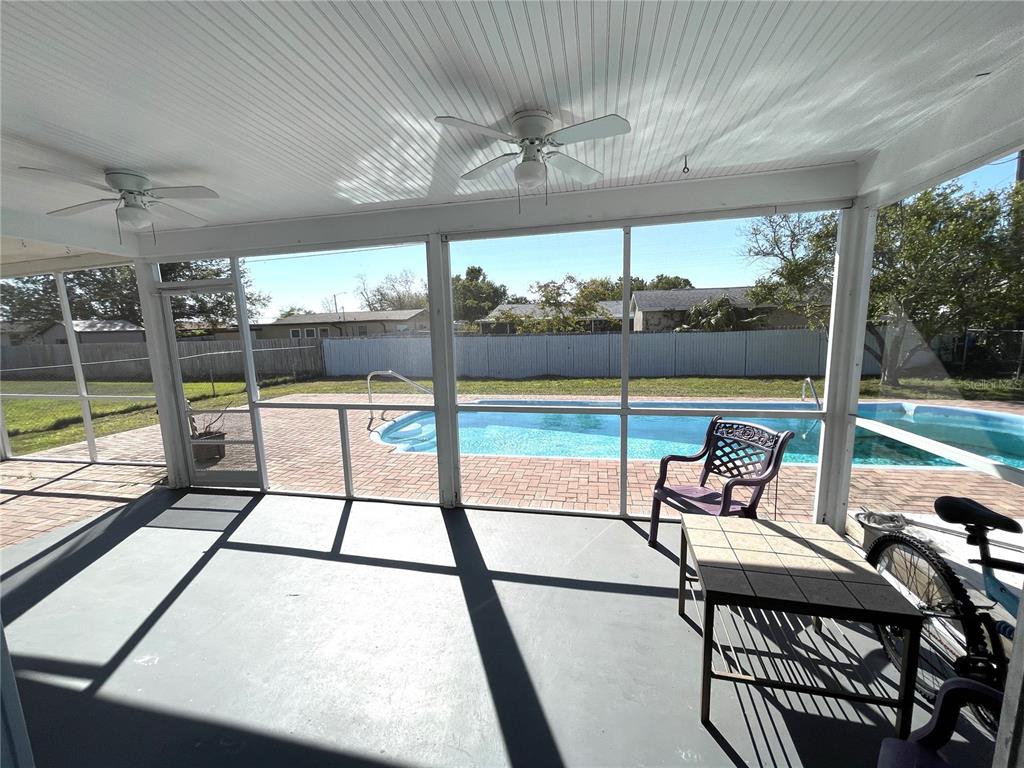 234 Shadow Street Northwest Port Charlotte, FL 33952 - Photo 8 of 48 a view of a porch with furniture and wooden deck