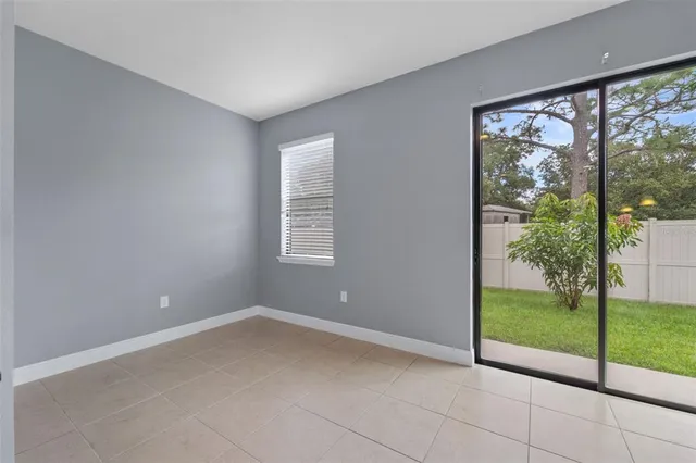 a view of a room with wooden floor and ceiling fan