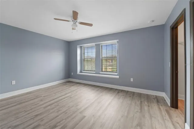 a view of an empty room with wooden floor