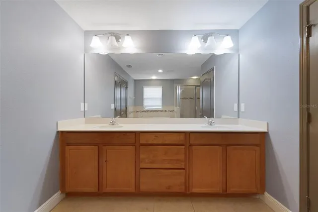 a view of backyard with barbeque grill potted plants and wooden fence