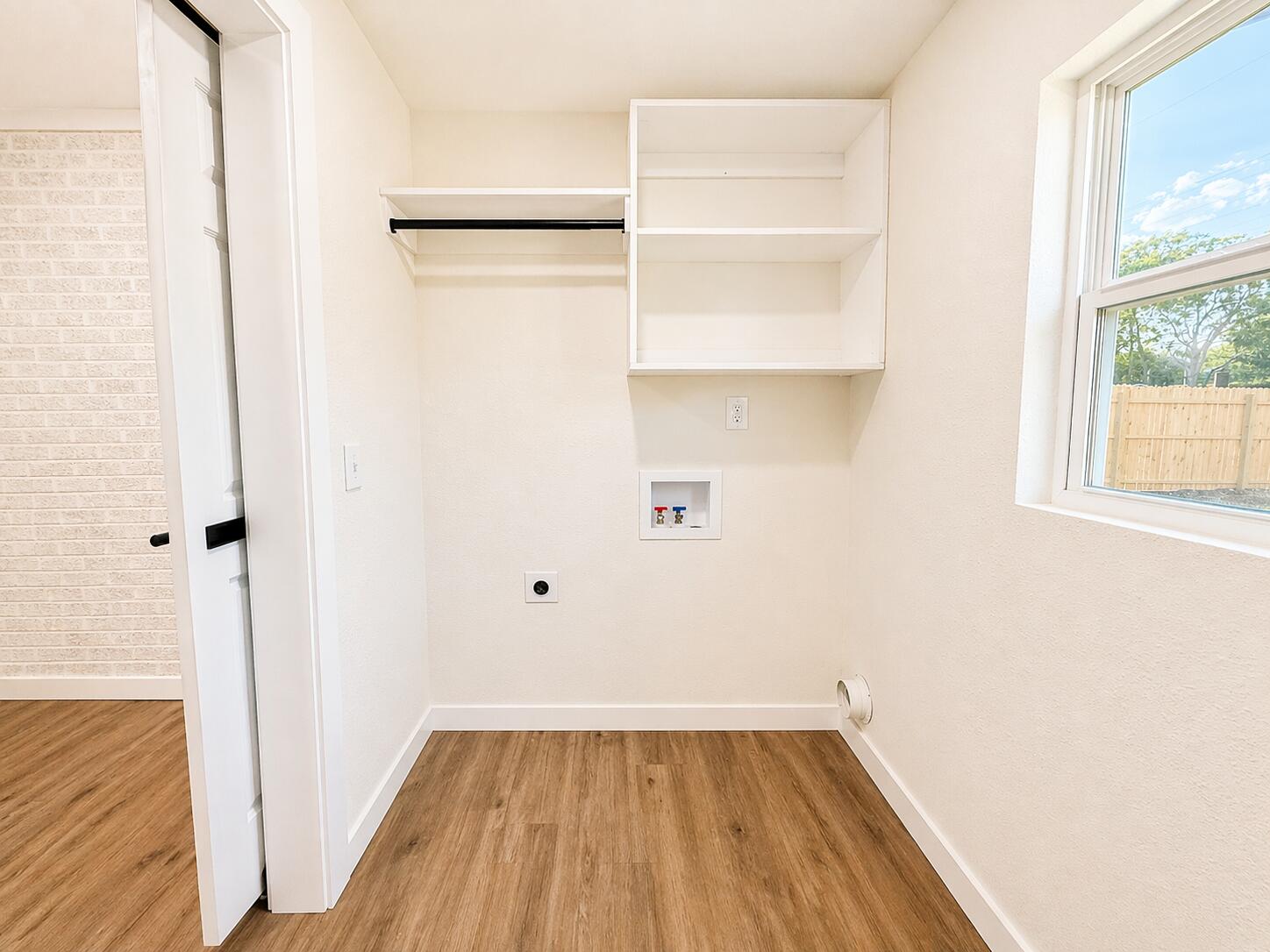 2316 48th Street Lubbock, TX 79412 - Photo 13 of 18 a view of a room with wooden floor and a window