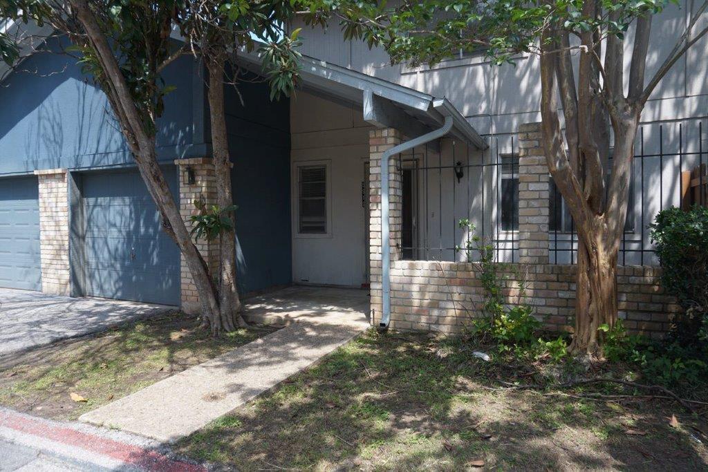 5919 Hidden Valley Trail Austin, TX 78744 - Photo 1 of 8 A welcoming brick and siding facade with a covered entry and attached garage.