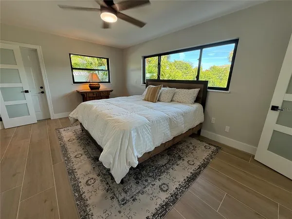 a bedroom with a bed and a large window