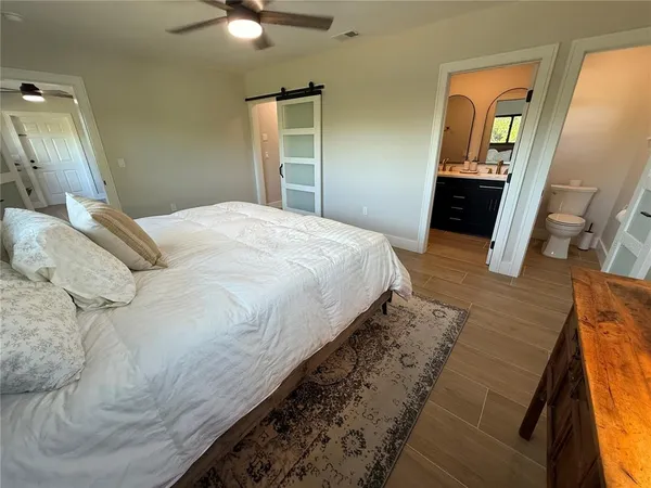 a bed sitting in a bedroom and a mirror