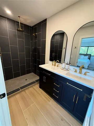 a bathroom with a double vanity sink and mirror