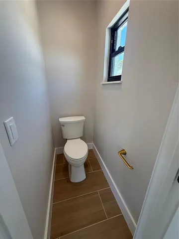 a white toilet sitting next to a white sink