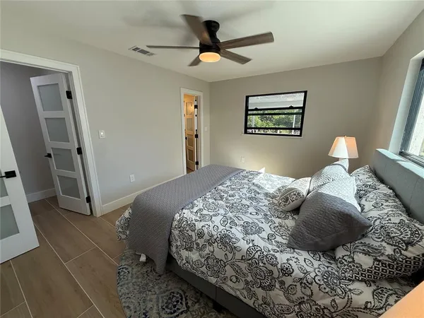 a bedroom with a large bed and a chandelier