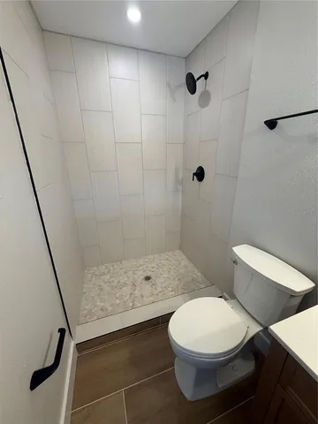 a bathroom with a toilet and a shower