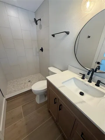 a bathroom with a sink toilet and shower