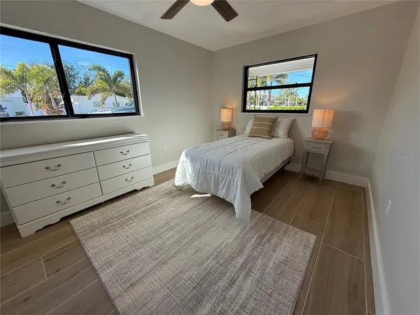 a spacious bedroom with a bed and a painting on the wall