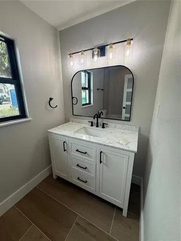 a bathroom with a double vanity sink and a mirror