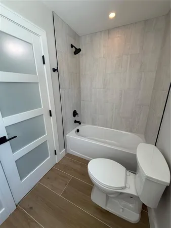a bathroom with a toilet and a shower