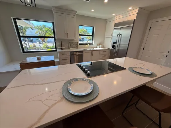 a kitchen with a table chairs and a refrigerator