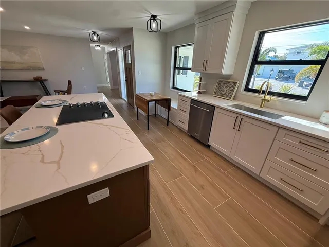 a kitchen with a sink a stove and a refrigerator