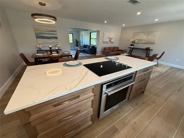 a kitchen with stainless steel appliances a stove a sink and a refrigerator