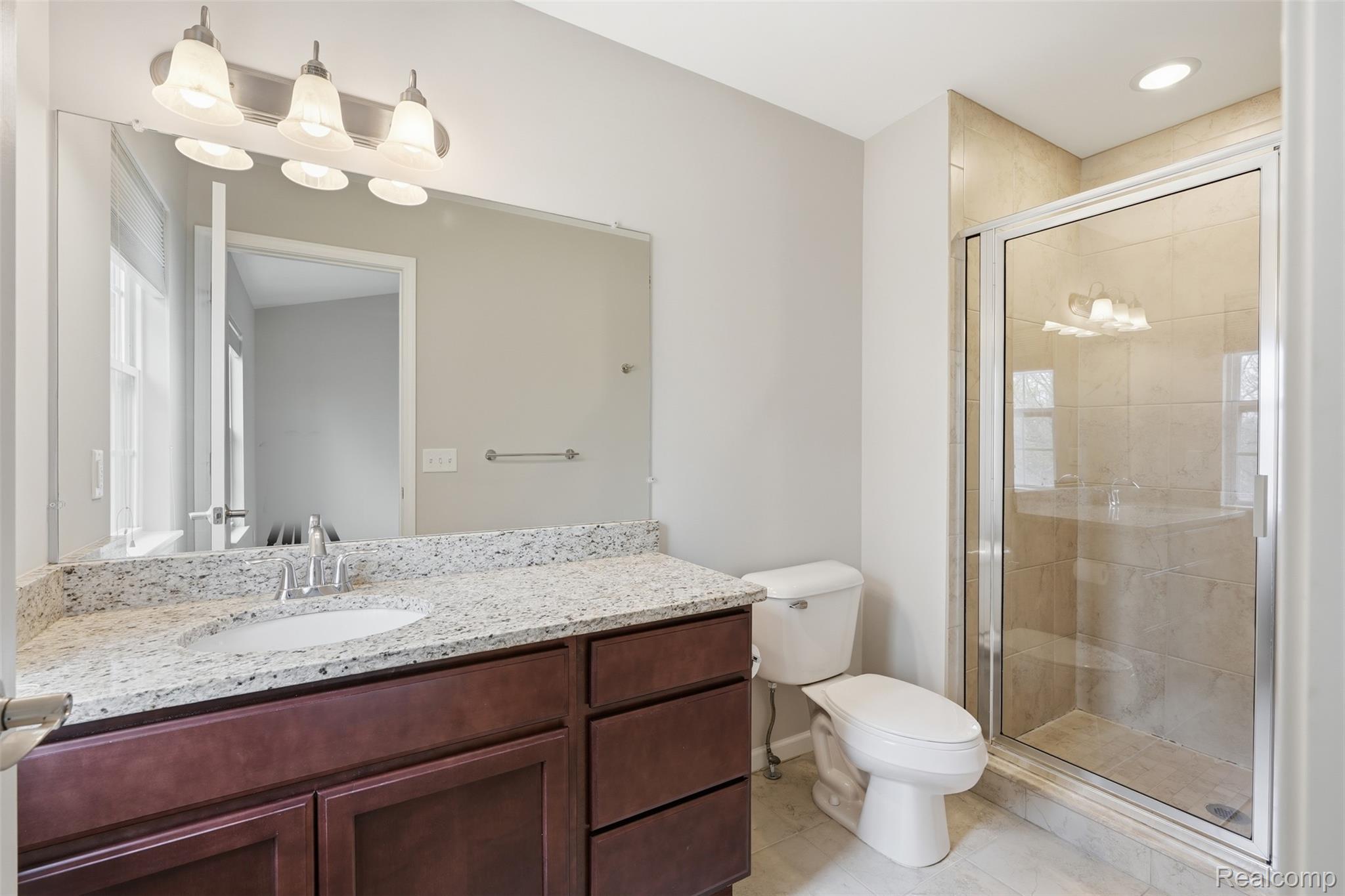 41594 Mitchell Road Novi, MI 48377 - Photo 20 of 35 Ensuite bathroom featuring a shower stall, vanity, recessed lighting, and light tile patterned floors