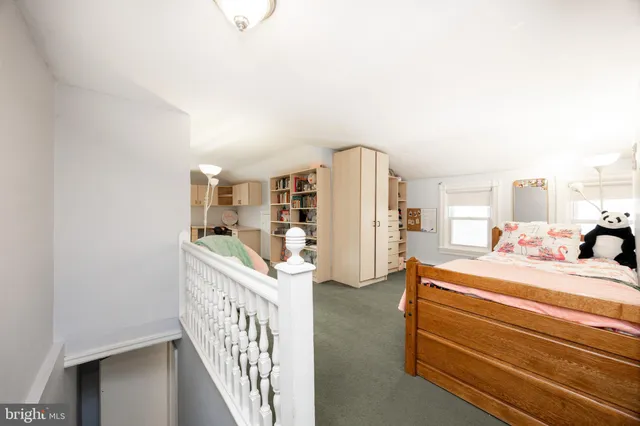 a room with a bed and a large window