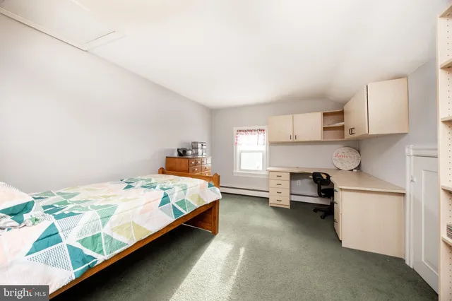 a bed room with a bed and a chair