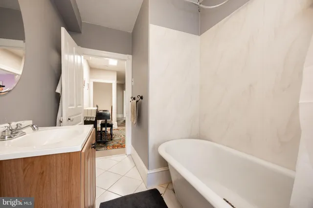 a bathroom with a bathtub a sink a toilet and a mirror