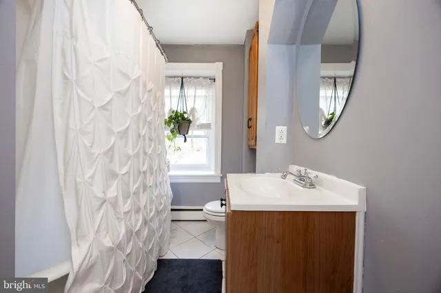 a bathroom with a sink a mirror and a shower