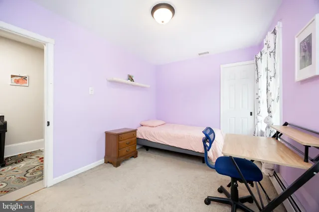 a bedroom with a bed and a chair