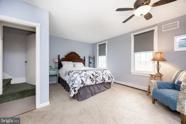 a bedroom with a bed couch and window