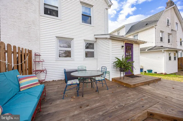 a backyard of a house with barbeque oven table and chairs