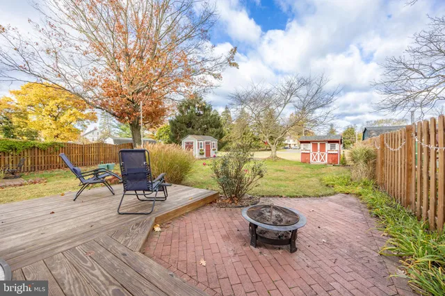 a front view of a house with garden and seating area