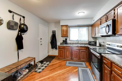 a kitchen with a refrigerator and a stove top oven