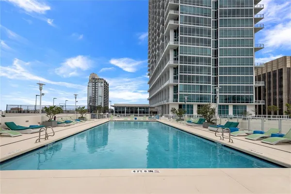 a outdoor view with a swimming pool and sitting space
