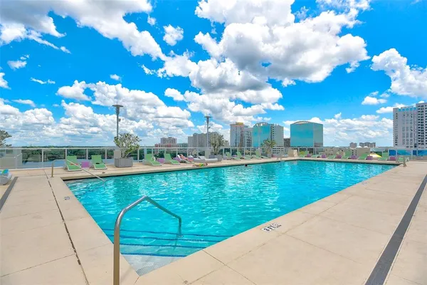 a view of a swimming pool with outdoor seating