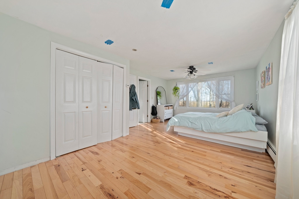 44 Jayna Way Marshfield, MA 02050 - Photo 13 of 27 a spacious bedroom with a bed and a chandelier