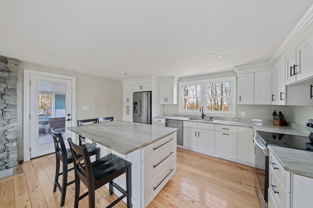 44 Jayna Way Marshfield, MA 02050 - Photo 5 of 27 a kitchen with a table chairs sink and cabinets