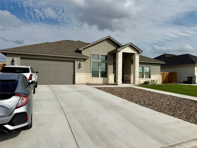 a front view of a house with a yard and garage