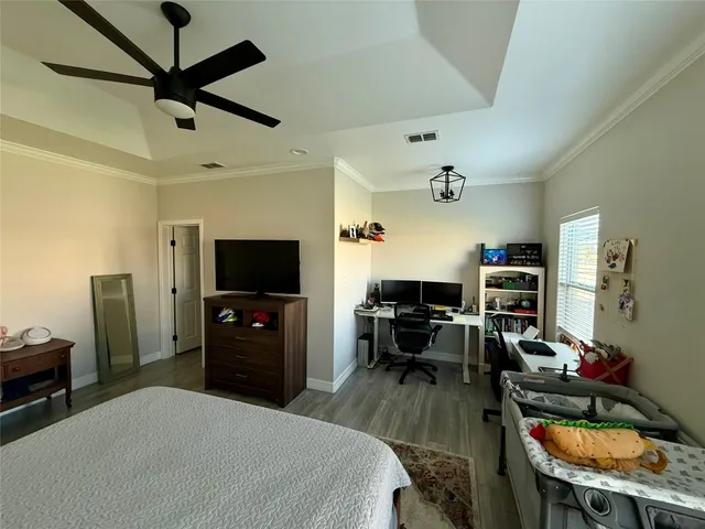 a bedroom with a bed and a flat screen tv