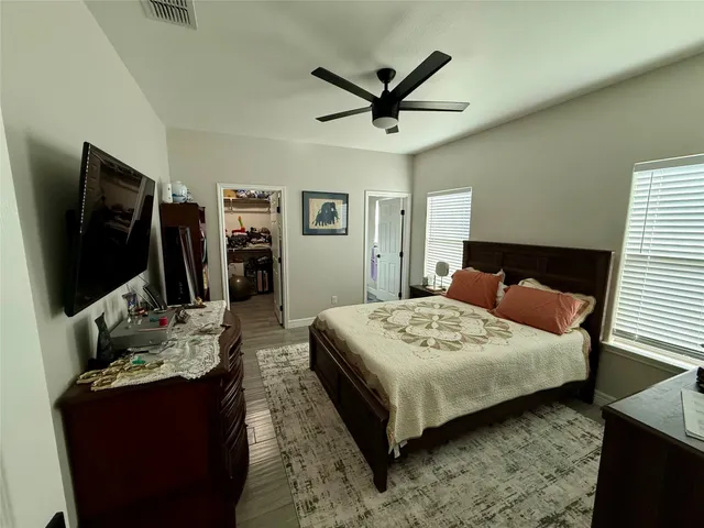 a living room with bed and a flat screen tv