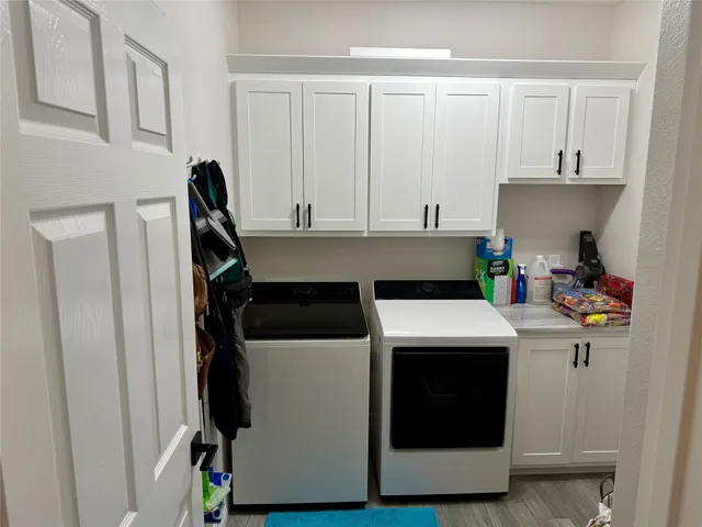 a kitchen with a stove and white cabinets