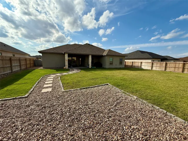 a bathroom with a granite countertop sink a toilet a mirror and shower